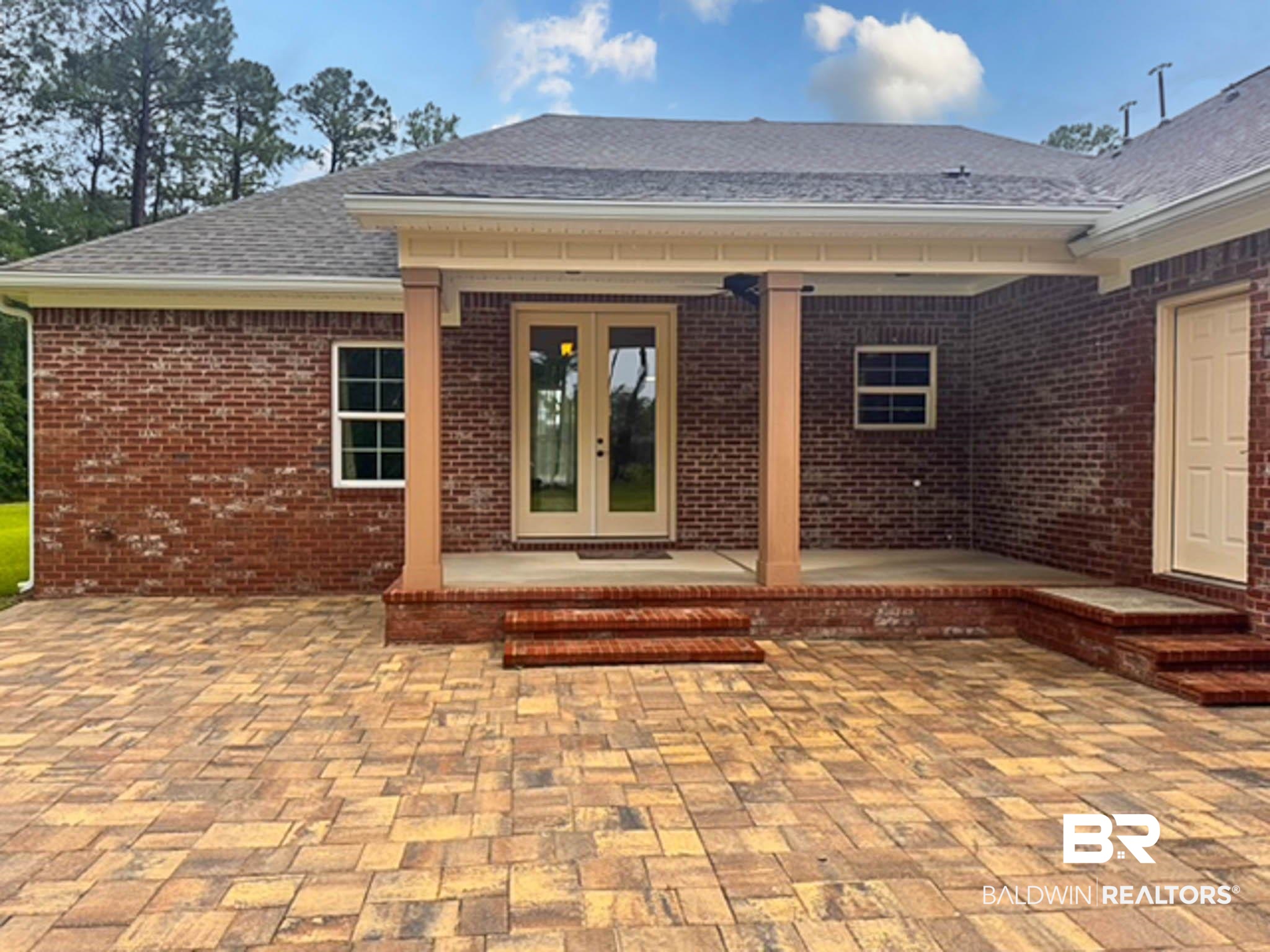 8145 Bay View Drive Foley, AL 36535 - Photo 53 of 81 View of exterior entry with french doors, brick siding, a patio, and roof with shingles