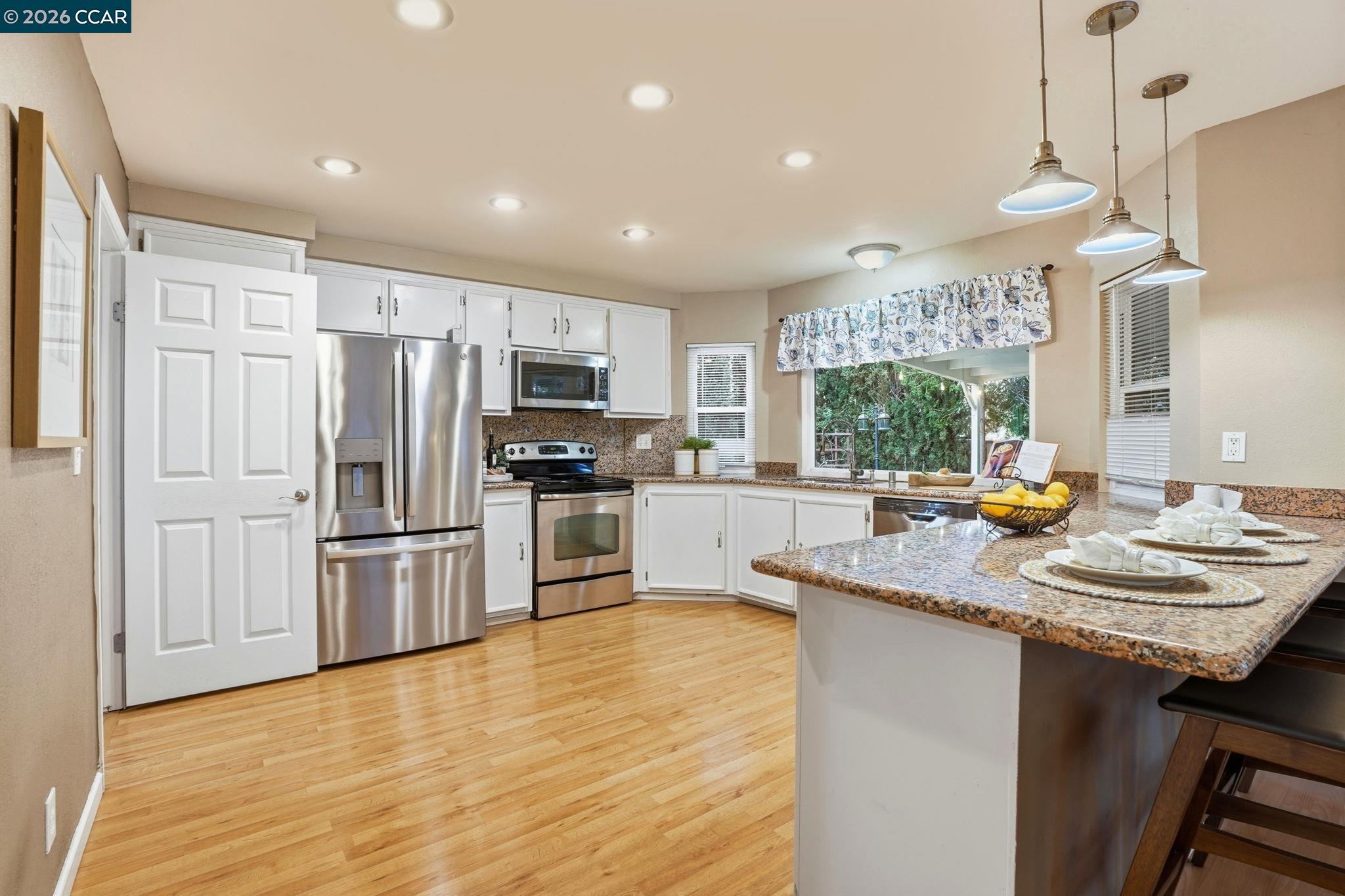 5454 Anselmo Court Concord, CA 94521 - Photo 14 of 44 a kitchen with stainless steel appliances granite countertop a sink refrigerator and cabinets