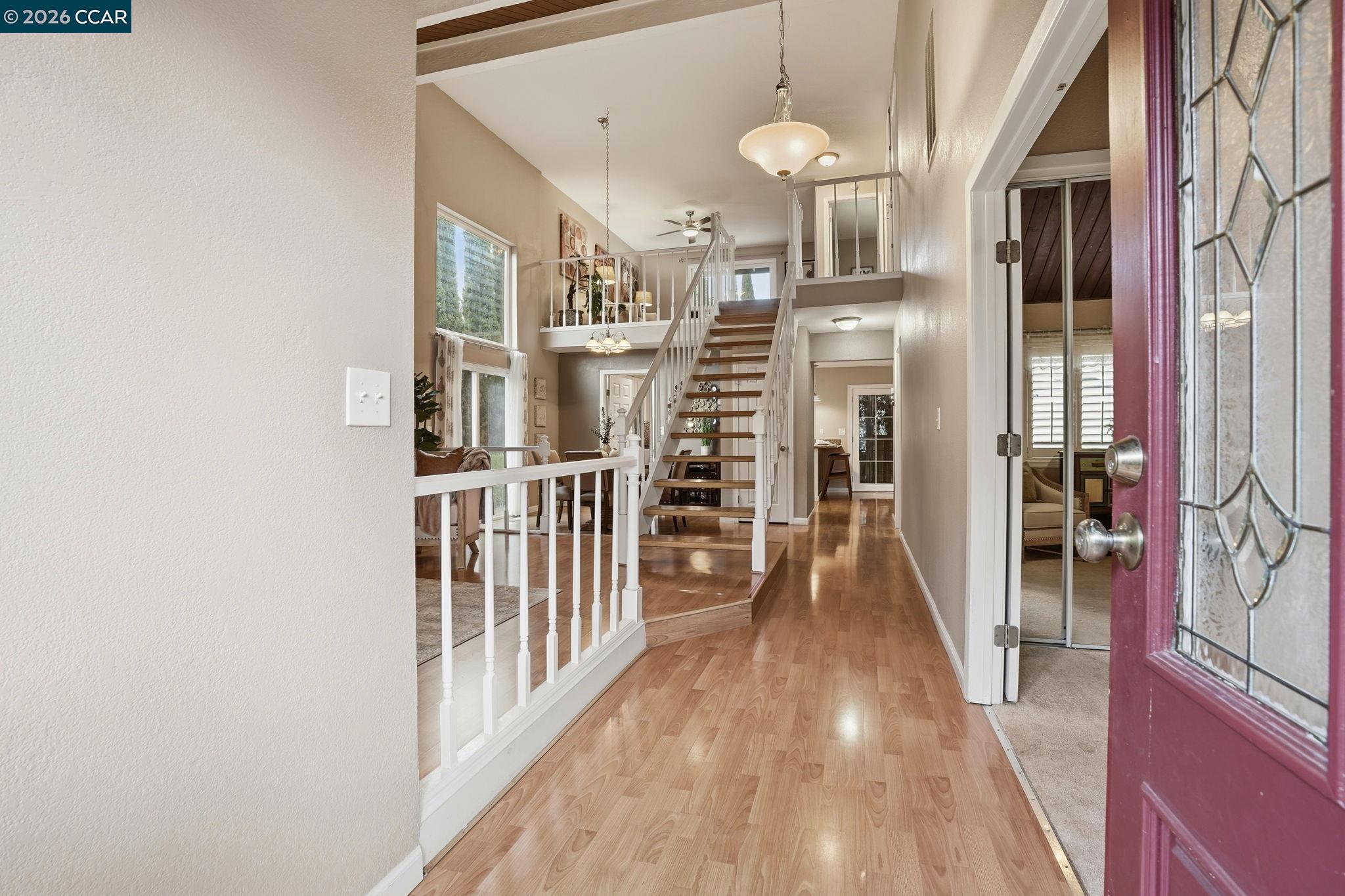 5454 Anselmo Court Concord, CA 94521 - Photo 4 of 44 a view of a hallway with wooden floor and staircase