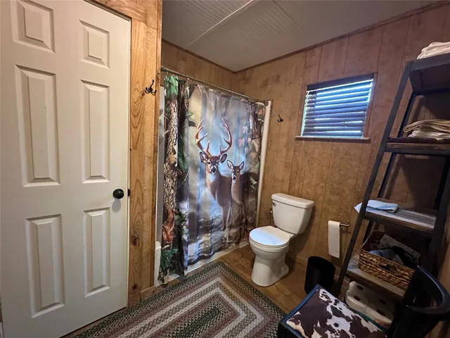 a bathroom with a toilet and a shower