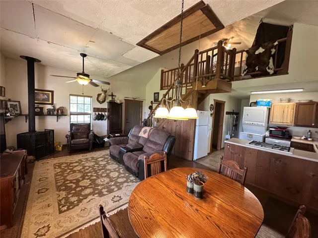 a room with furniture cabinetry and a chandelier