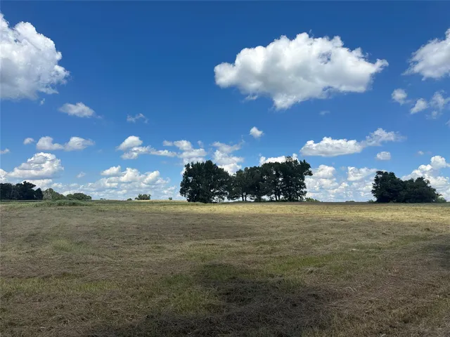 a view of a lake in between two and trees