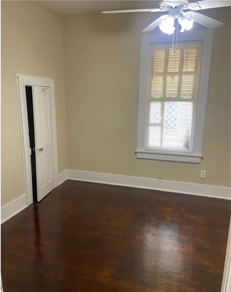 2917 13th Avenue Columbus, GA 31904 - Photo 2 of 6 an empty room with wooden floor and windows