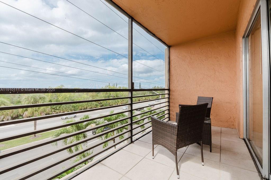 3110 North Pine Island Road, Unit 409 Sunrise, FL 33351 - Photo 1 of 18 a view of chairs and bench in patio