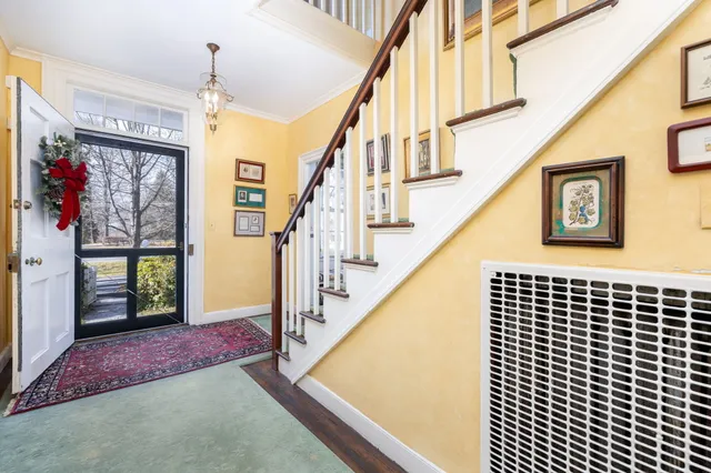 a view of staircase with lots of frames and couches