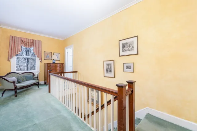 a living room with furniture and a lamp