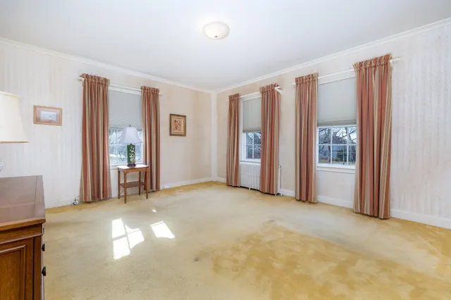 a living room filled with furniture and a floor to ceiling window