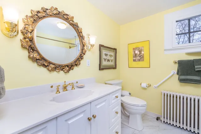 a spacious bedroom with a bed and a chandelier