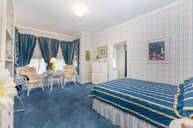 a spacious bedroom with a bed and a cabinets