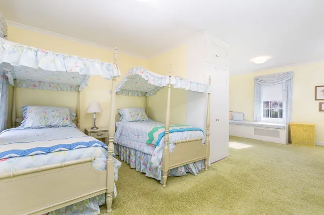 a front view of a house with a yard and swimming pool