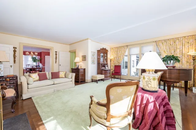 a living room with furniture fireplace and a large window