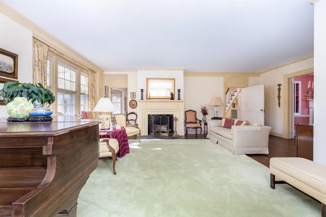 a living room with furniture a fireplace and a large window