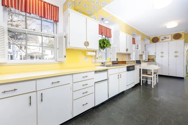 a kitchen with cabinets and window