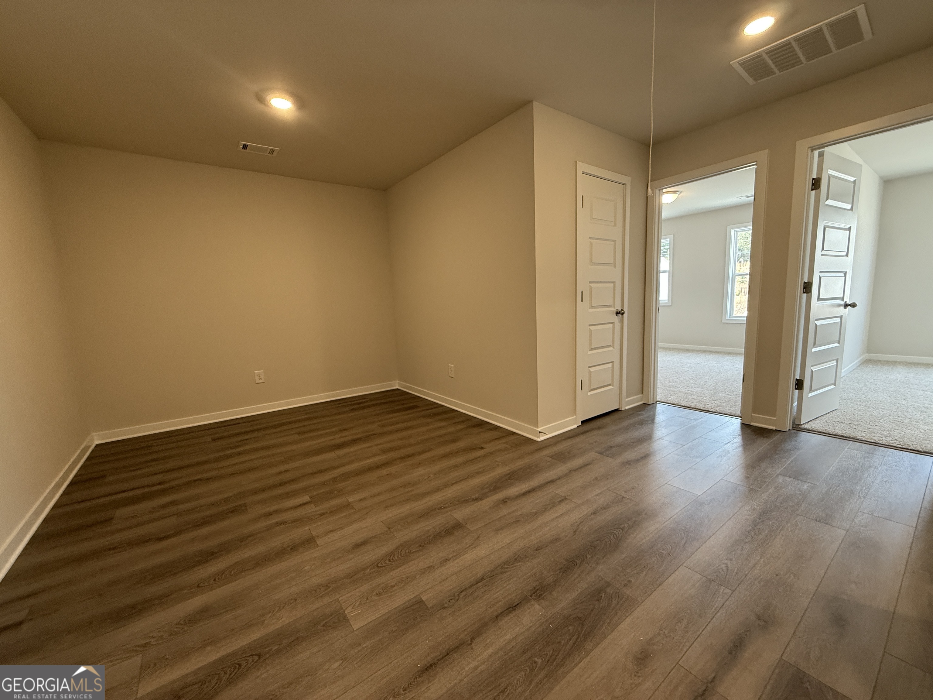 182 Depot Landing Road, Unit 65A Auburn, GA 30011 - Photo 14 of 36 wooden floor in an empty room