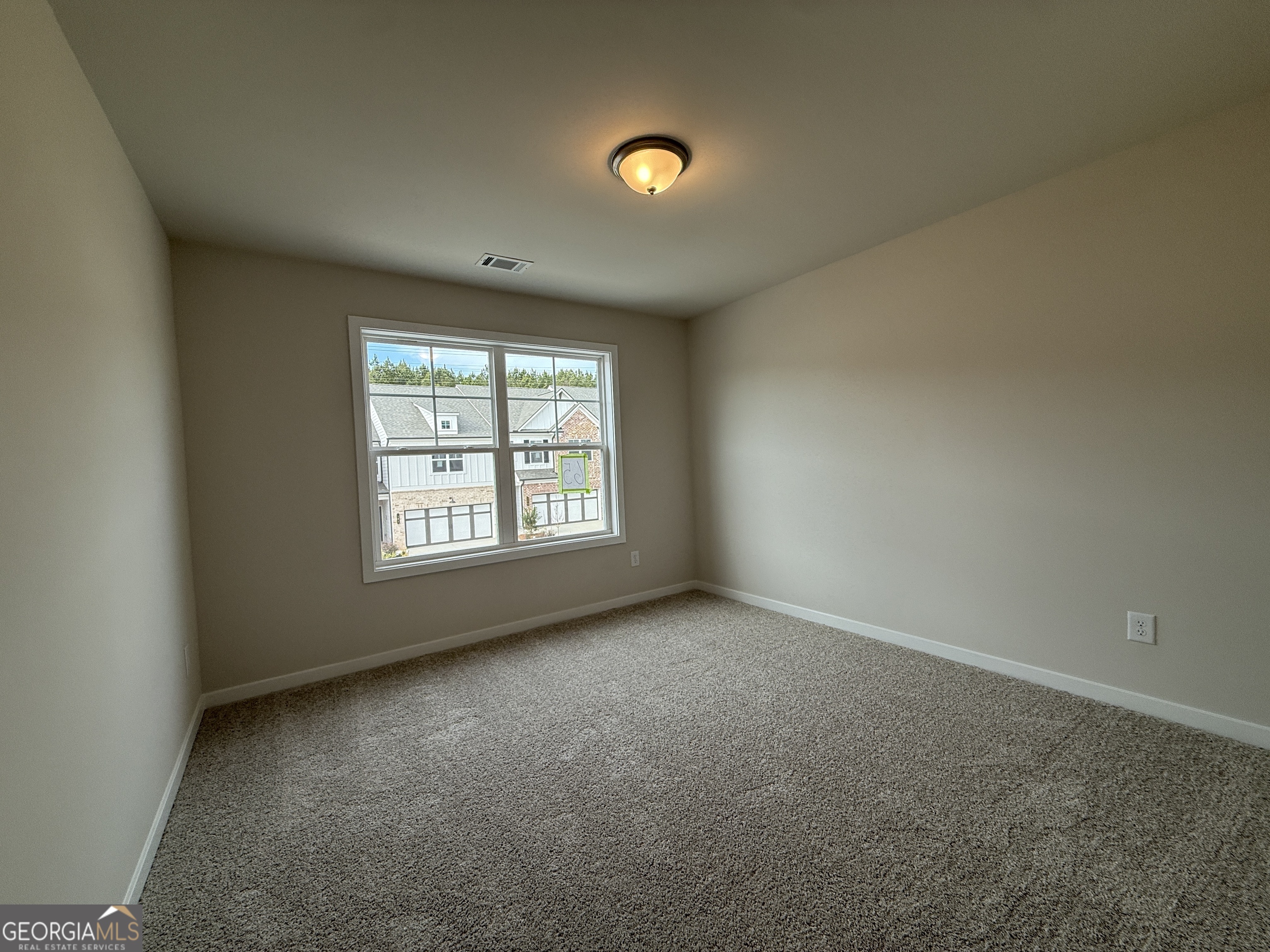 182 Depot Landing Road, Unit 65A Auburn, GA 30011 - Photo 17 of 36 an empty room with windows and yard