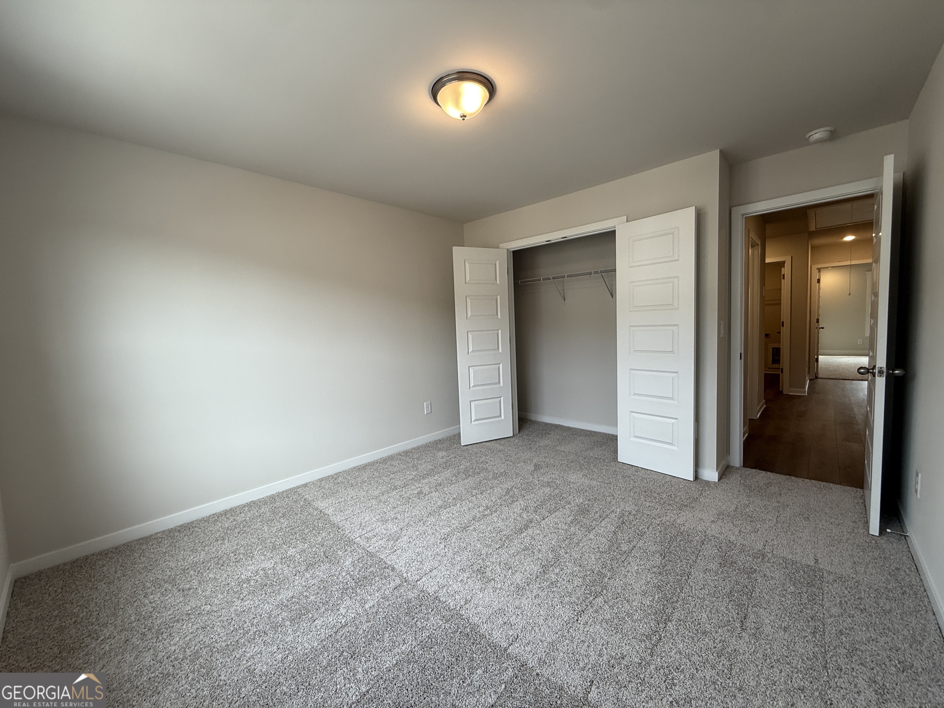 182 Depot Landing Road, Unit 65A Auburn, GA 30011 - Photo 18 of 36 an empty room with closet and mirror