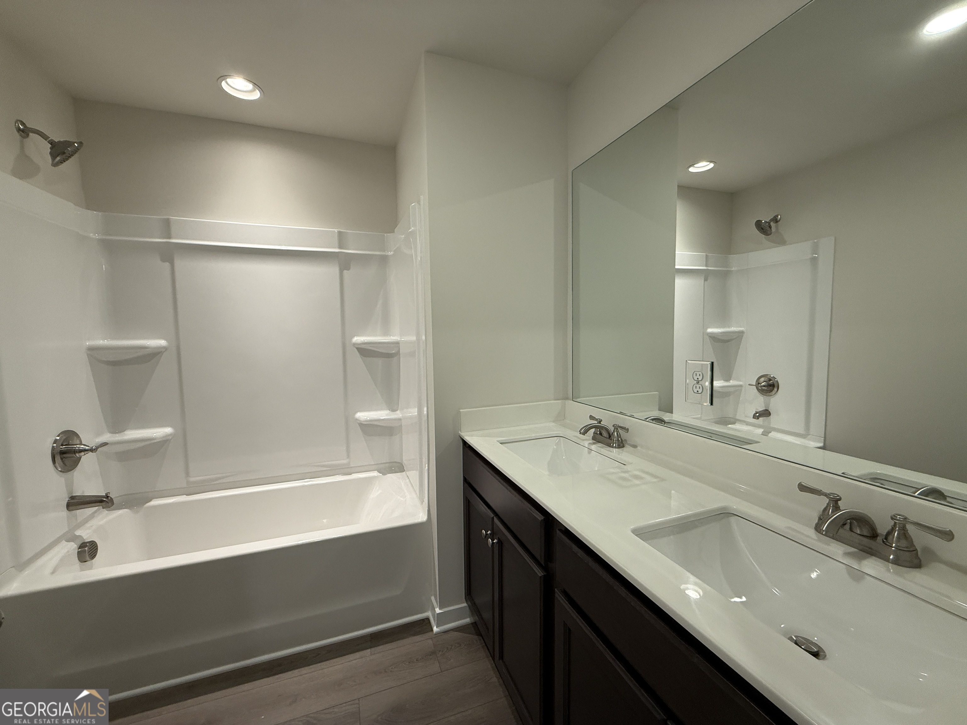 182 Depot Landing Road, Unit 65A Auburn, GA 30011 - Photo 20 of 36 a bathroom with a tub sink double vanity and mirror