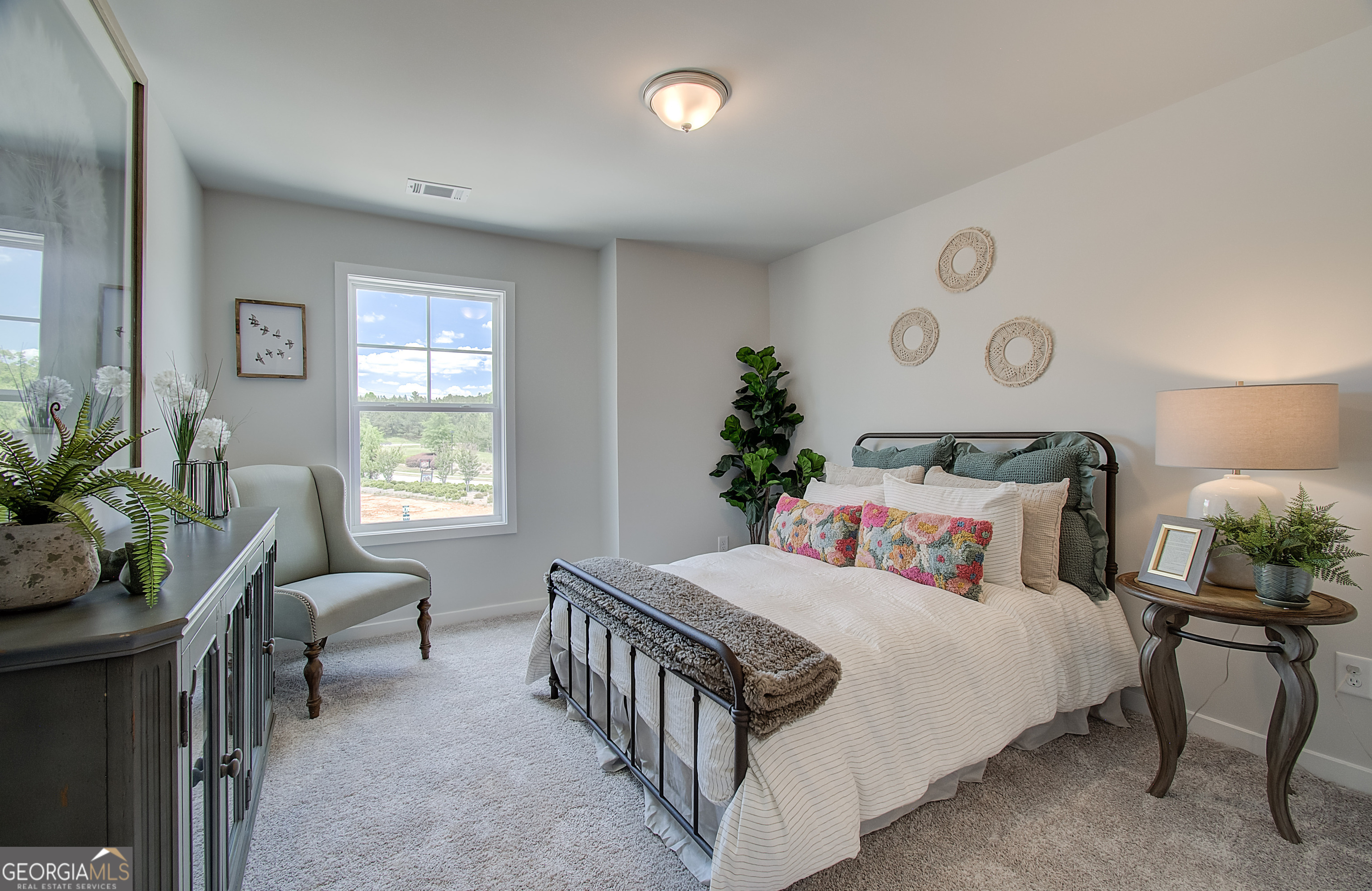 182 Depot Landing Road, Unit 65A Auburn, GA 30011 - Photo 20 of 37 a bedroom with a bed and a chair