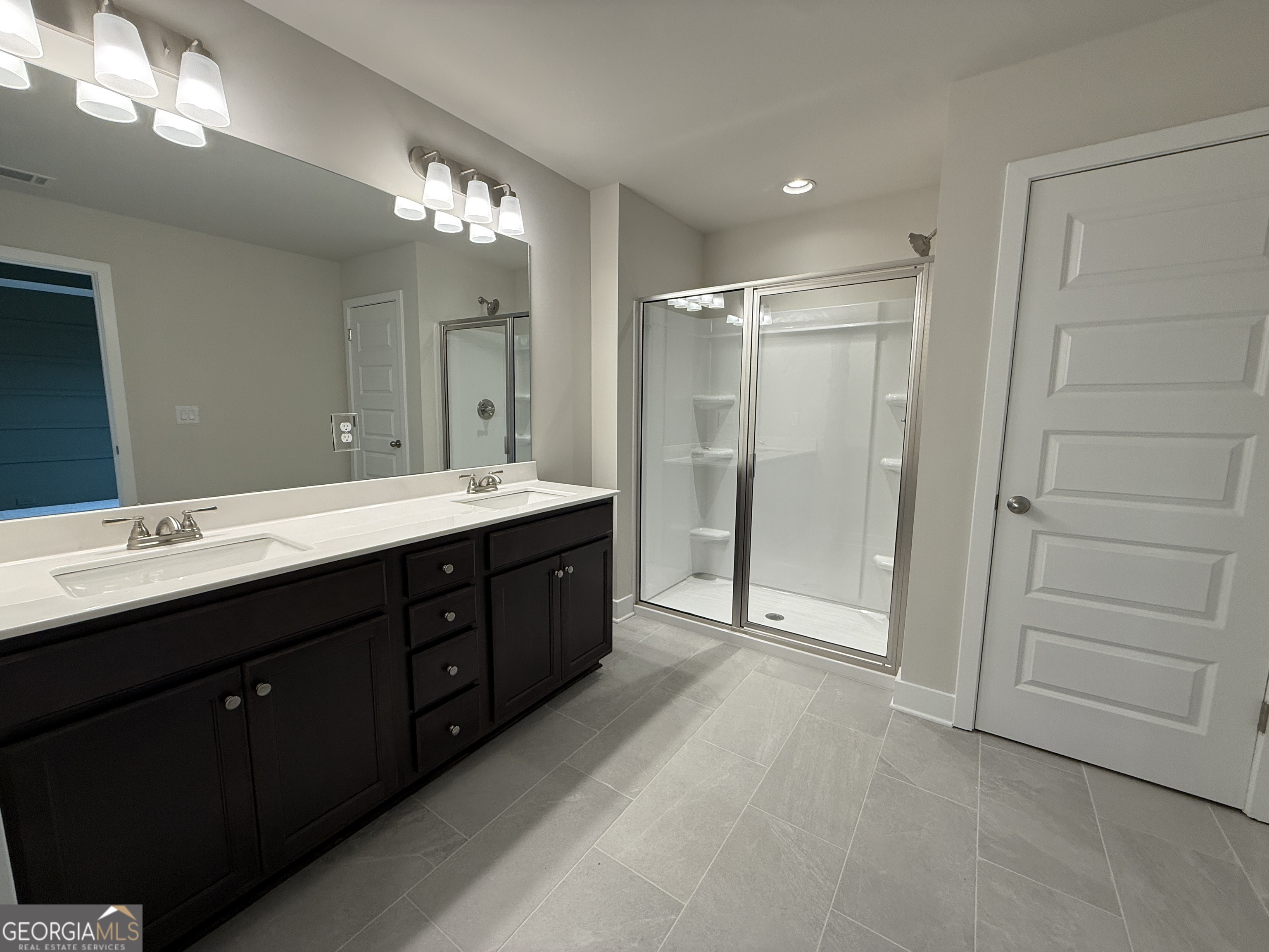 182 Depot Landing Road, Unit 65A Auburn, GA 30011 - Photo 23 of 36 a spacious bathroom with a double vanity sink a large mirror and a shower