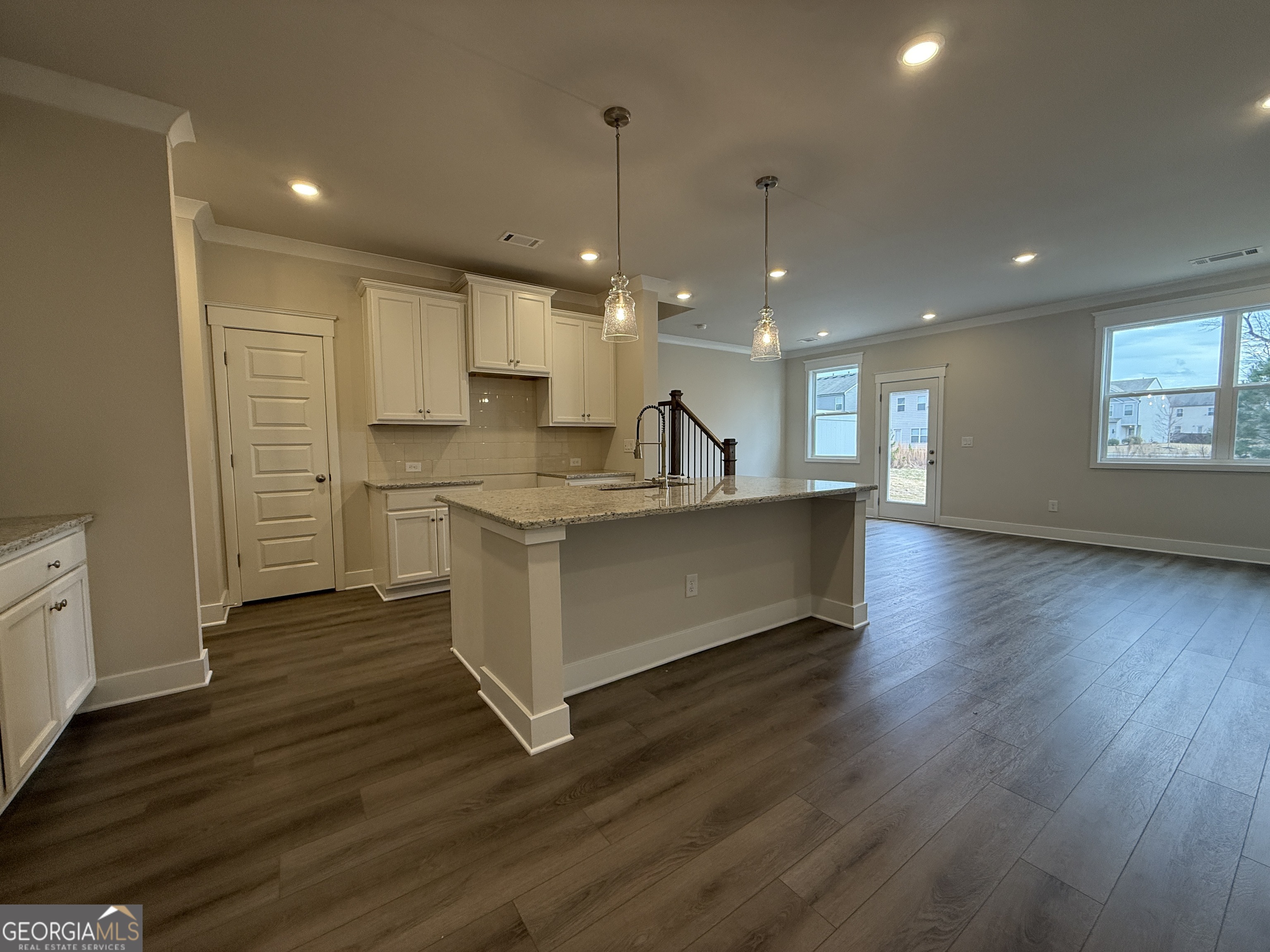 182 Depot Landing Road, Unit 65A Auburn, GA 30011 - Photo 4 of 36 a large kitchen with stainless steel appliances a large counter top a sink a refrigerator and a window