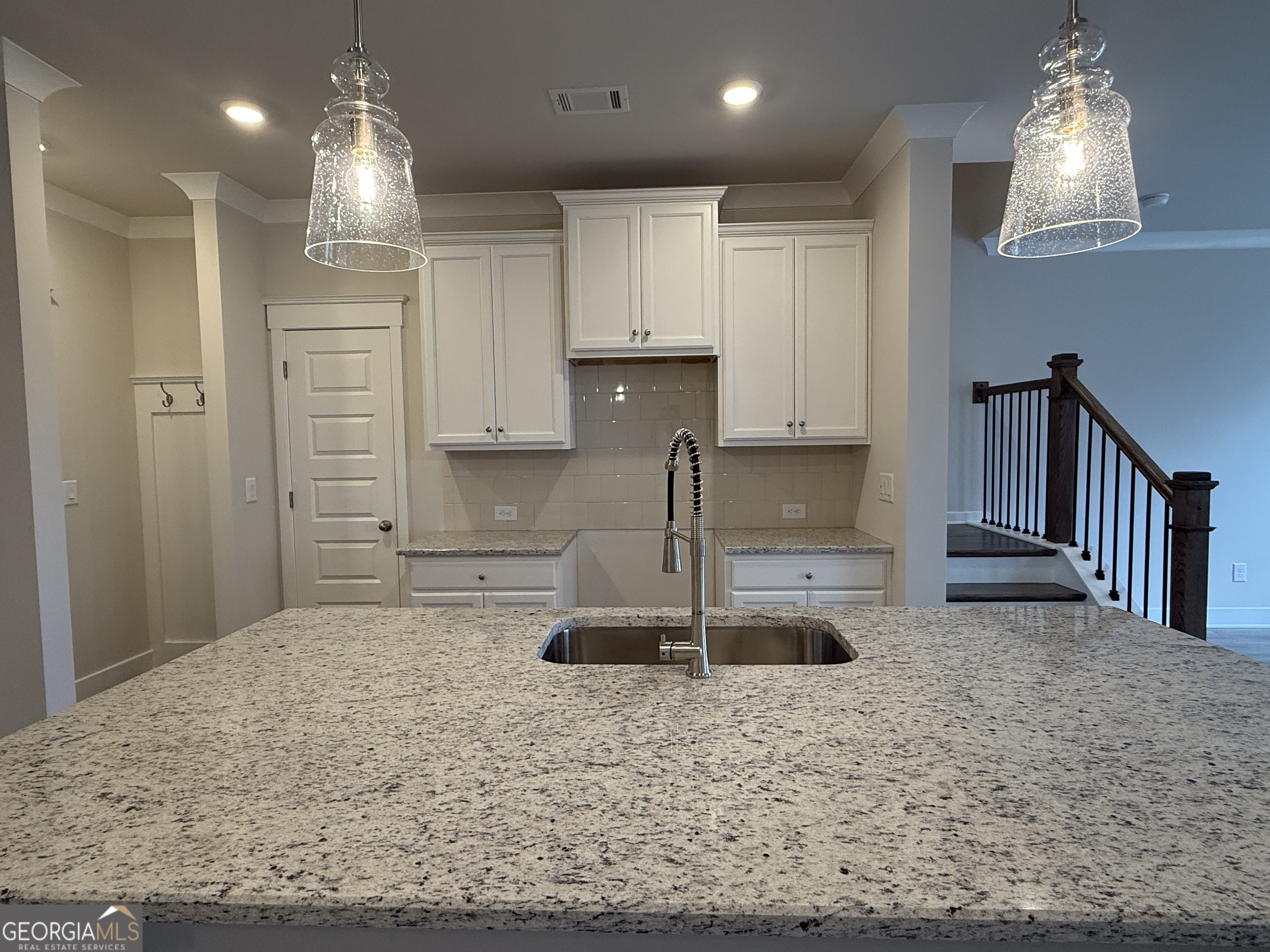 182 Depot Landing Road, Unit 65A Auburn, GA 30011 - Photo 5 of 36 a kitchen with kitchen island granite countertop a sink and a refrigerator
