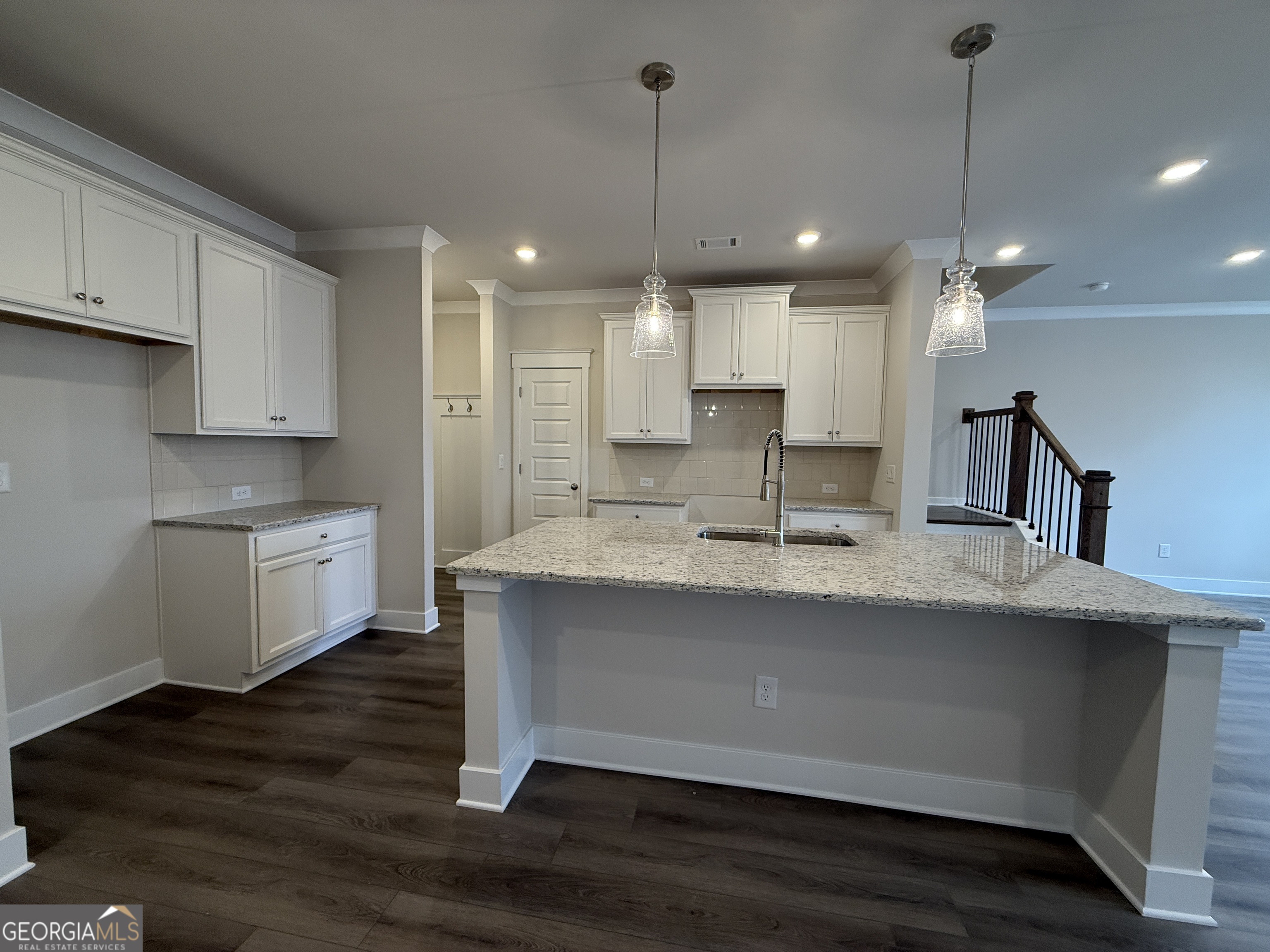 182 Depot Landing Road, Unit 65A Auburn, GA 30011 - Photo 6 of 36 a view of a kitchen with kitchen island a sink stainless steel appliances and cabinets