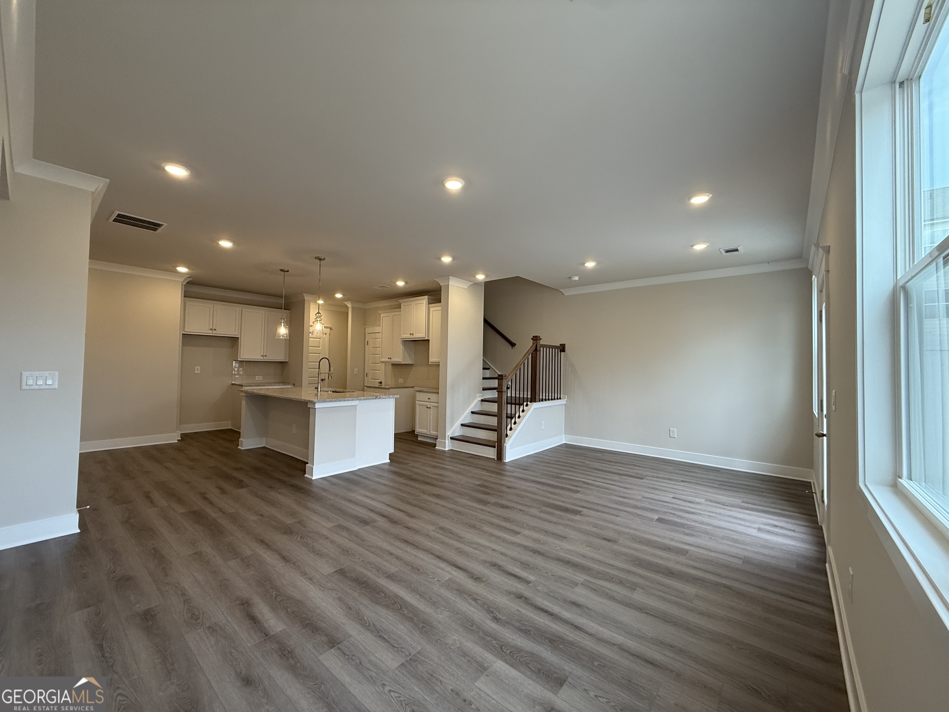 182 Depot Landing Road, Unit 65A Auburn, GA 30011 - Photo 8 of 36 a view of a big room with wooden floor and windows