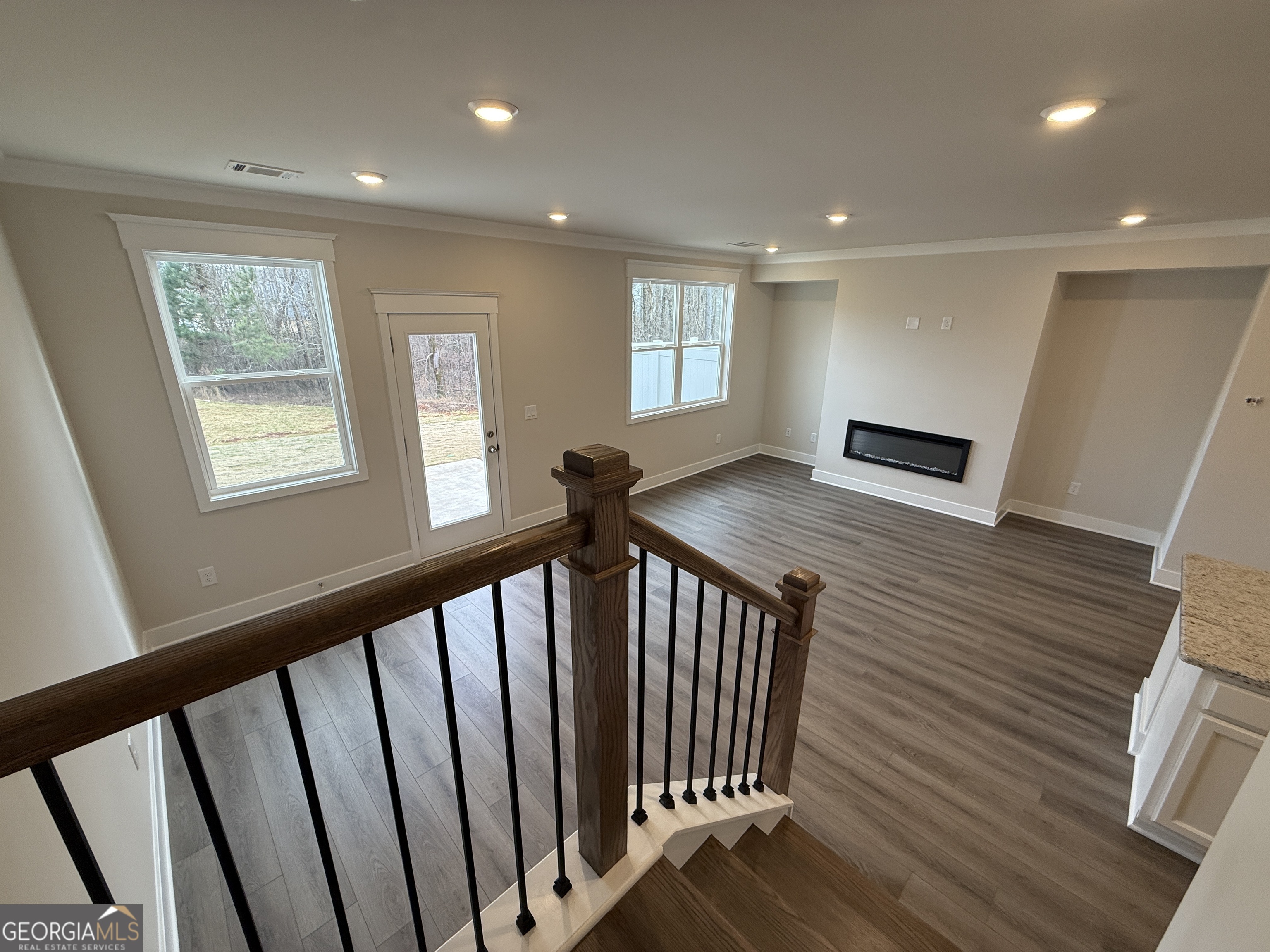 182 Depot Landing Road, Unit 65A Auburn, GA 30011 - Photo 10 of 36 a view of a hallway with wooden floor and staircase