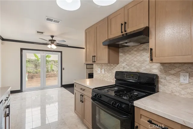a kitchen with stainless steel appliances granite countertop a stove and a refrigerator