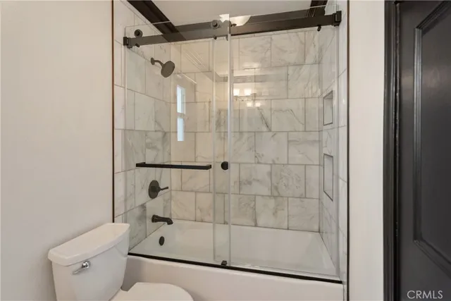 a bathroom with a shower and toilet