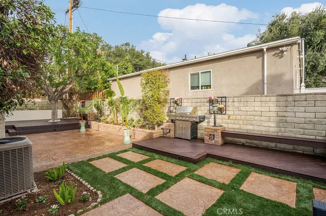 a view of a back yard of the house with a patio