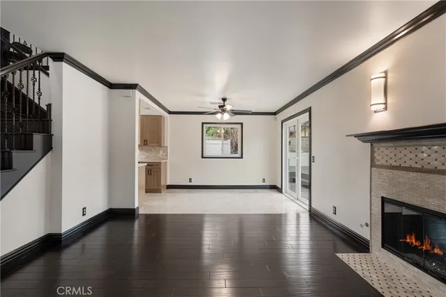 a view of a livingroom with wooden floor and a fireplace