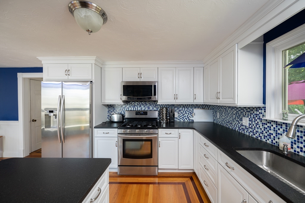 29 Wituwamat Road Weymouth, MA 02191 - Photo 15 of 42 a kitchen with a sink stove and refrigerator