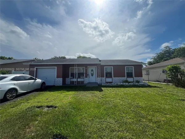a view of a house with a back yard