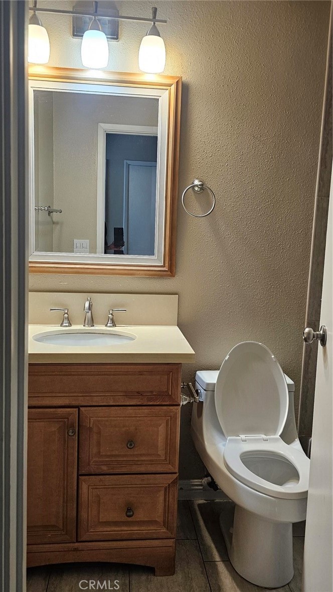 18206 Vía Dicha, Unit 3 Rowland Heights, CA 91748 - Photo 7 of 11 a bathroom with a toilet a sink and mirror