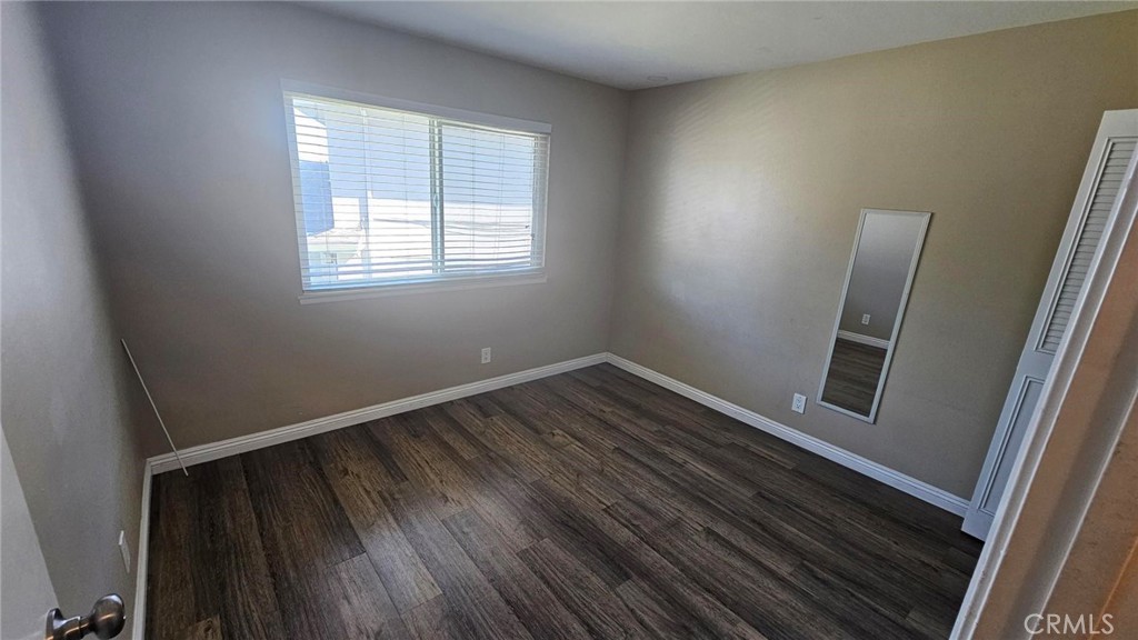 18206 Vía Dicha, Unit 3 Rowland Heights, CA 91748 - Photo 8 of 11 a view of an empty room with wooden floor and a window