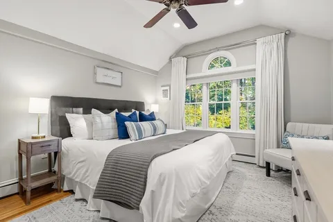 a bed room with a bed and a chair