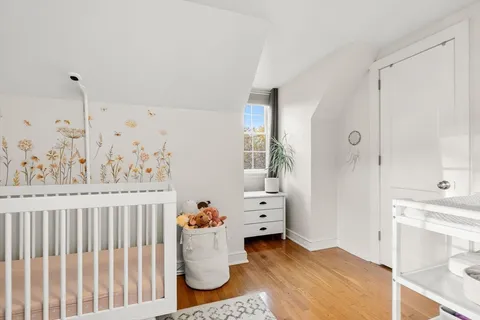 a view of a room that has a bed and a window in it