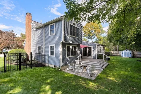 a front view of a house with a yard table and chairs