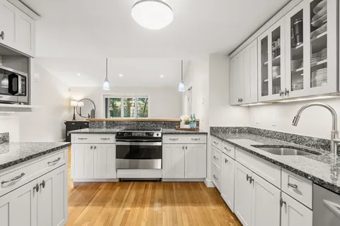 a kitchen with stainless steel appliances granite countertop a stove and a sink