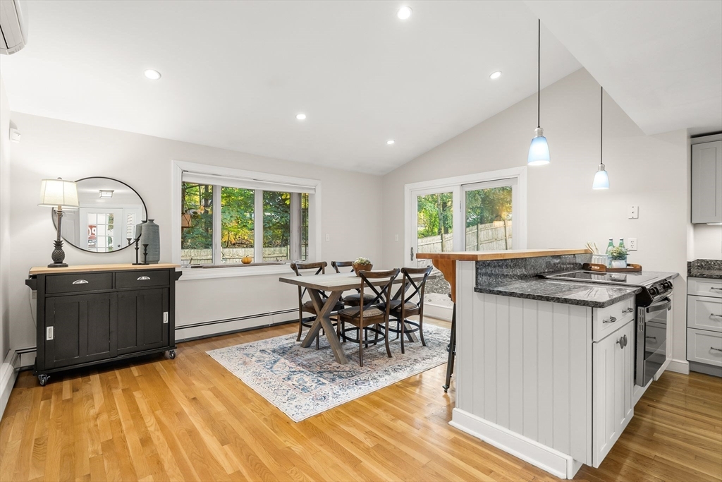15 Bayberry Road Hingham, MA 02043 - Photo 7 of 24 a kitchen with stainless steel appliances granite countertop a stove top oven a sink dishwasher and a dining table with garden view
