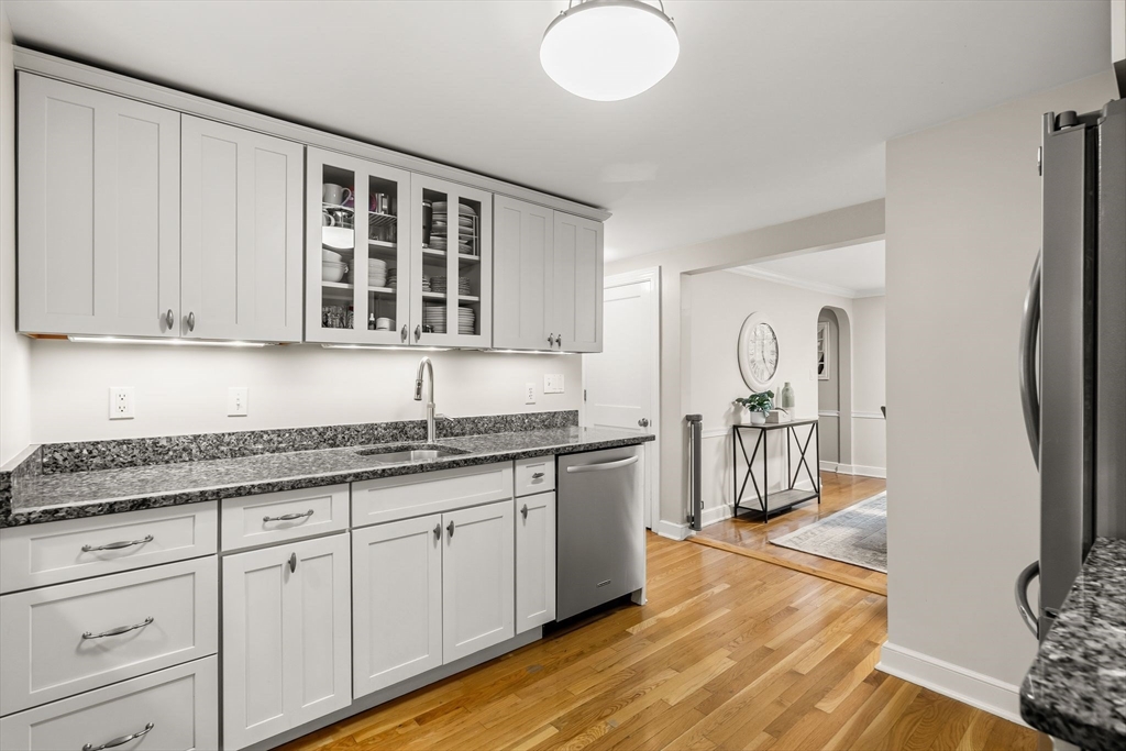 15 Bayberry Road Hingham, MA 02043 - Photo 8 of 24 a kitchen with stainless steel appliances granite countertop a stove a sink and white cabinets