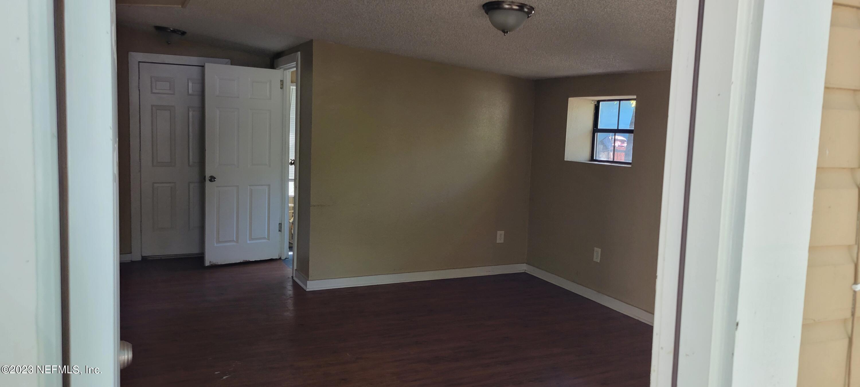 4069 Walnut Street Jacksonville, FL 32206 - Photo 11 of 14 an empty room with wooden floor and closet