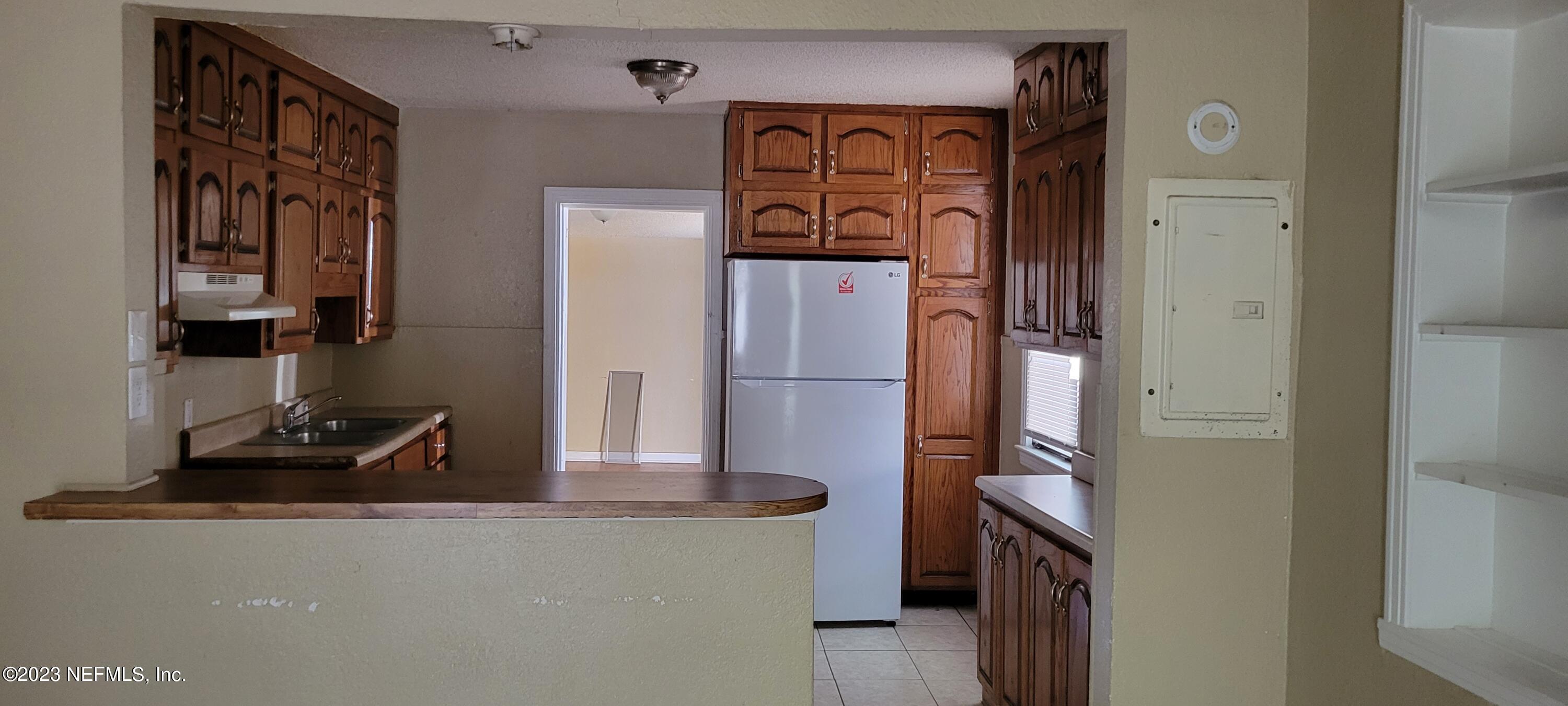 4069 Walnut Street Jacksonville, FL 32206 - Photo 6 of 14 a kitchen with stainless steel appliances granite countertop a refrigerator and a stove