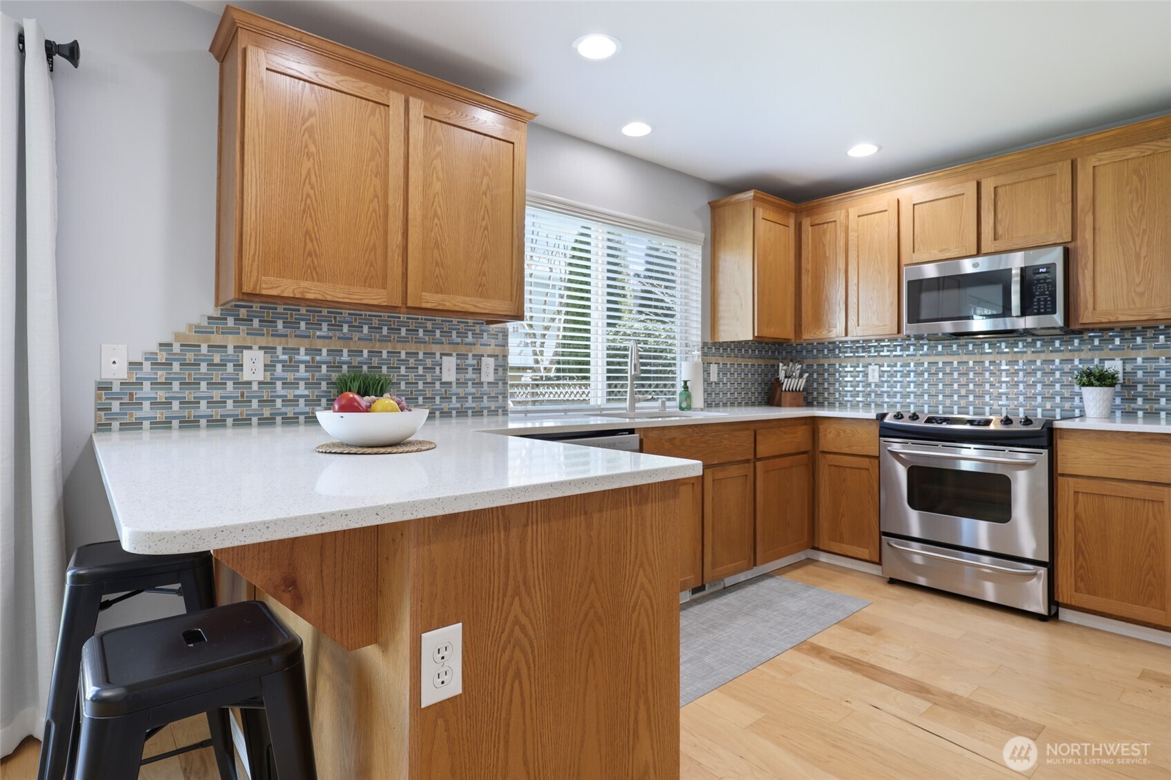 6914 Axis Street Southeast Lacey, WA 98513 - Photo 13 of 38 a kitchen with stainless steel appliances granite countertop a sink stove and refrigerator