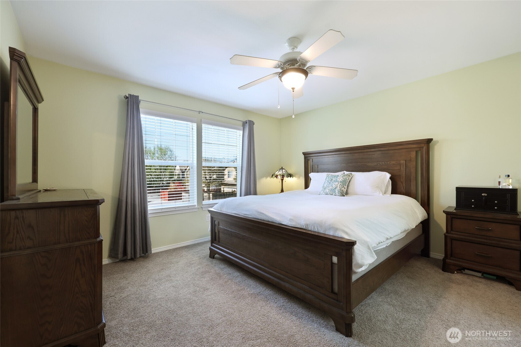 6914 Axis Street Southeast Lacey, WA 98513 - Photo 20 of 38 a bedroom with a large bed and a chandelier