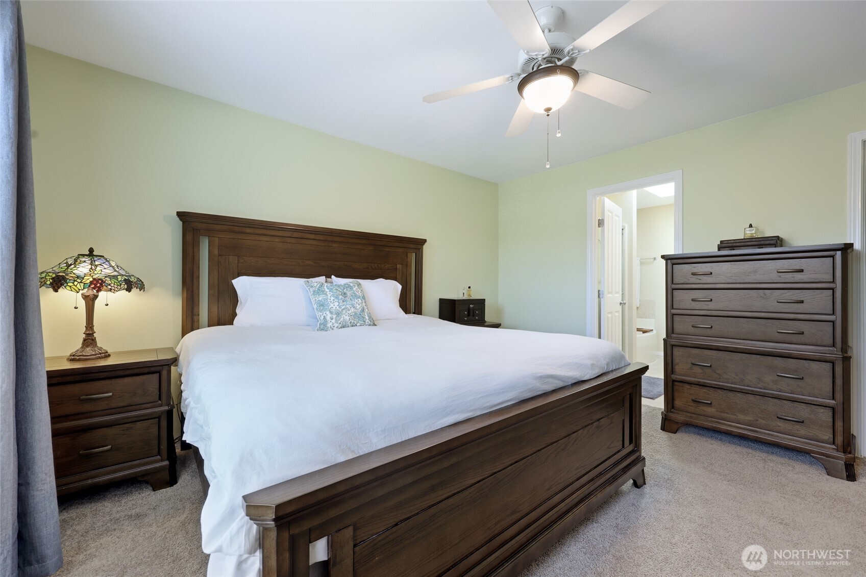 6914 Axis Street Southeast Lacey, WA 98513 - Photo 21 of 38 a bedroom with a bed and a chandelier