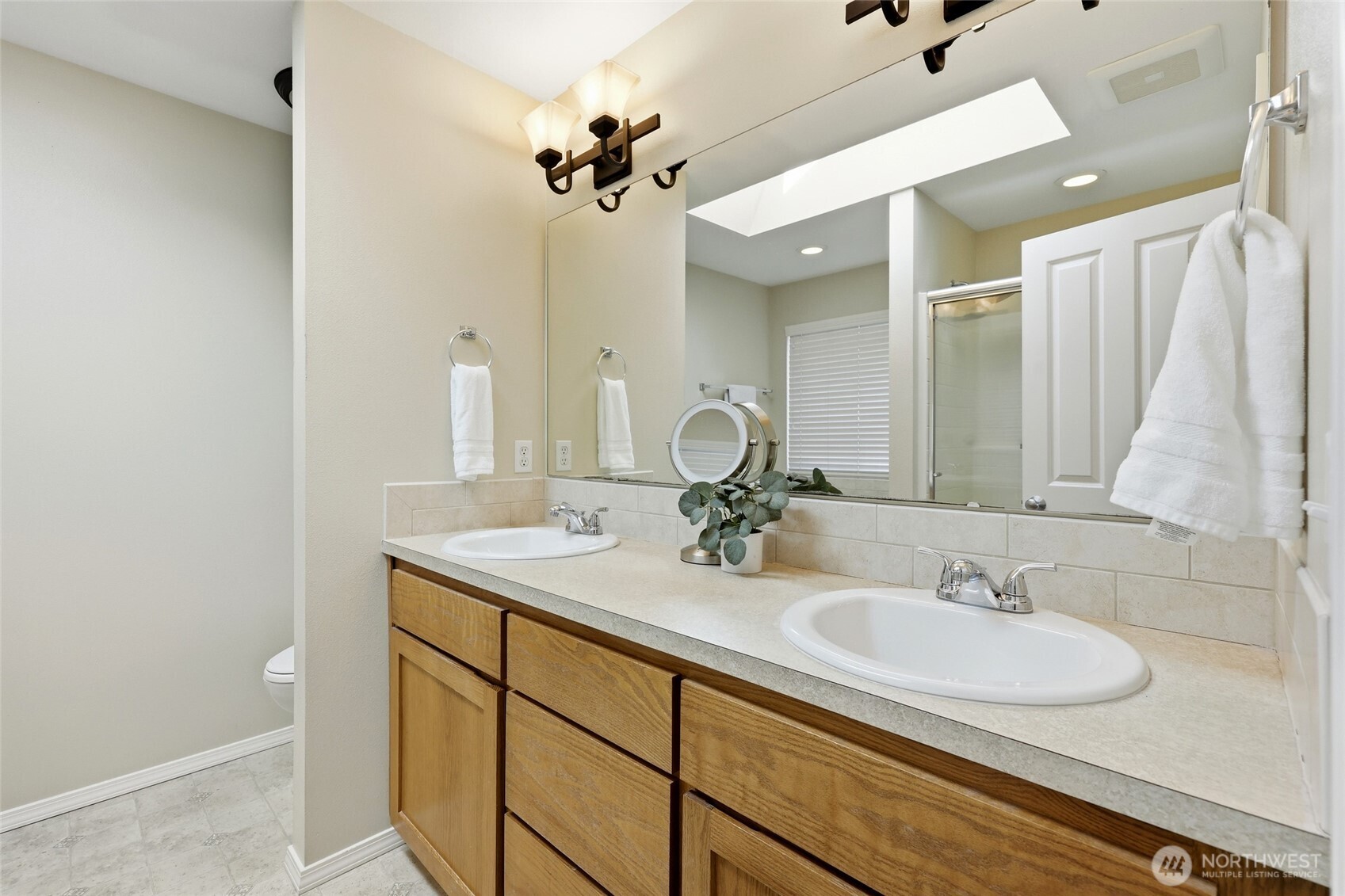 6914 Axis Street Southeast Lacey, WA 98513 - Photo 23 of 38 a bathroom with a sink double vanity and a mirror