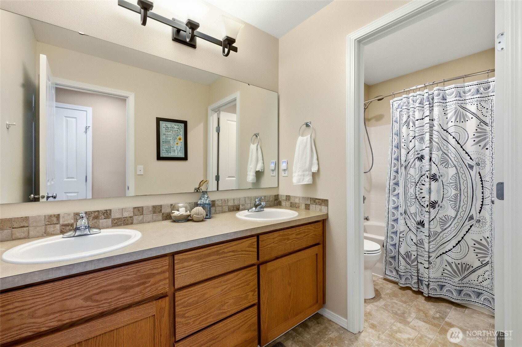 6914 Axis Street Southeast Lacey, WA 98513 - Photo 30 of 38 a bathroom with a granite countertop sink and a mirror