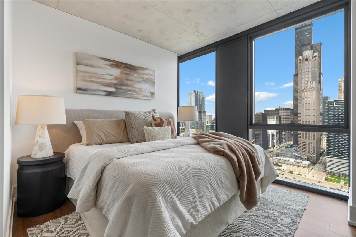234 West Polk Street, Unit 3708 Chicago, IL 60607 - Photo 13 of 44 a bedroom with bed and large window